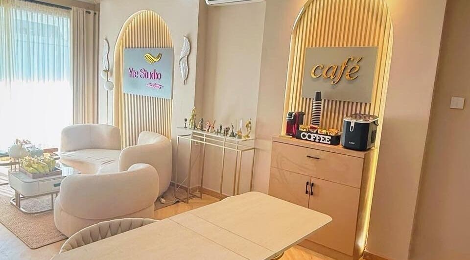 Inviting lounge at Yie Academy & Nail Studio, Bali, Bali ID with plush seating and café corner.