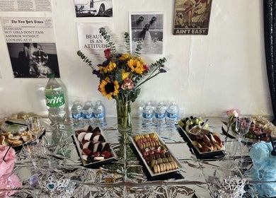 A luxurious table setup at Vintage Vanity in Shamokin, Pennsylvania, US with flowers, snacks, and drinks.