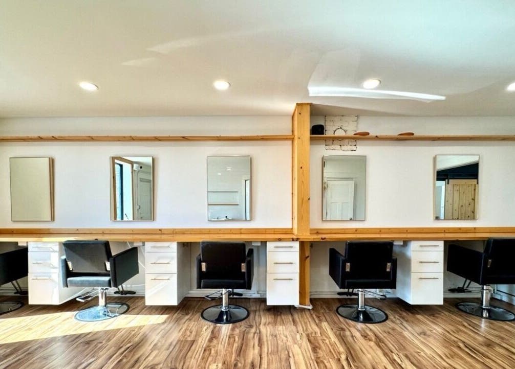 Interior of KC Braiding Bar, Kansas City, Missouri, US with stylish salon chairs and minimalist decor.