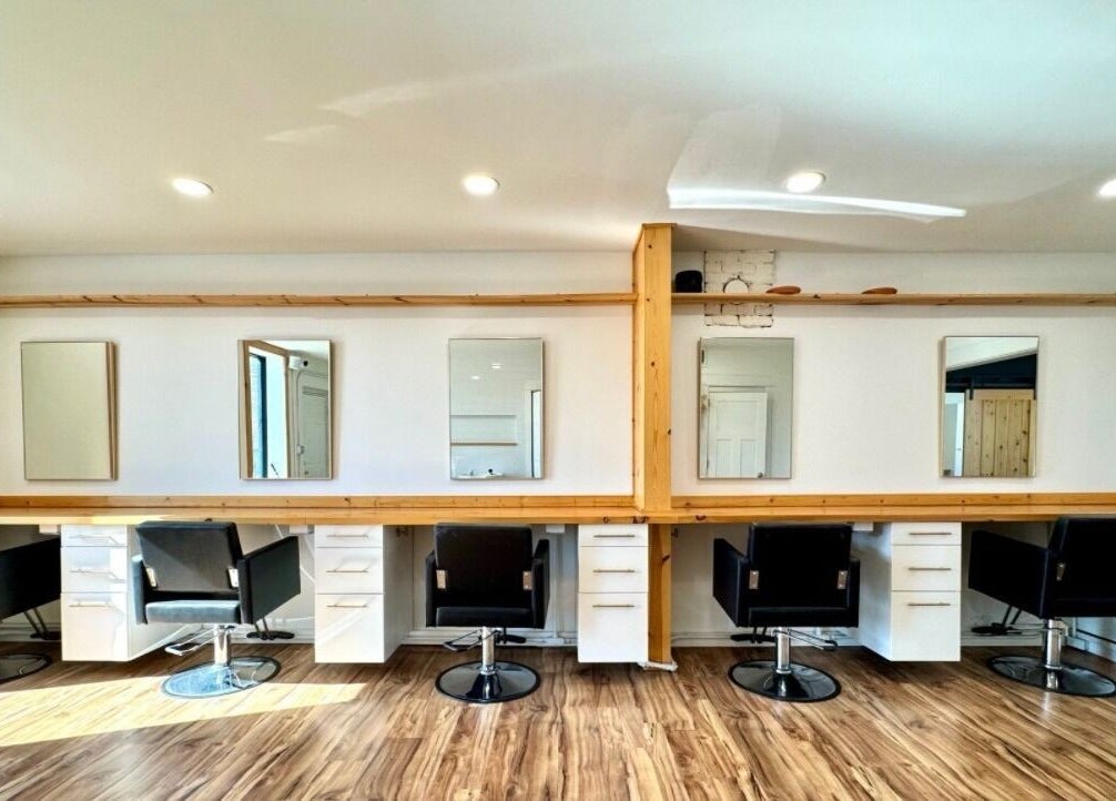 Interior of KC Braiding Bar, Kansas City, Missouri, US with stylish salon chairs and minimalist decor.