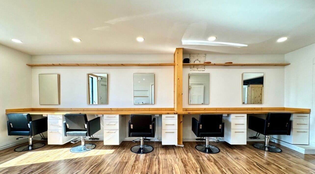 Interior of KC Braiding Bar, Kansas City, Missouri, US with stylish salon chairs and minimalist decor.