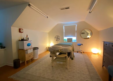 Cozy massage room at Zephyr Massage and Bodywork, North Little Rock, Arkansas, US, with ambient lighting.