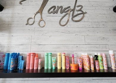 Variety of hair care products at Black Diamond Hair Salon, Churchbridge, Saskatchewan, CA, on a stylish shelf.