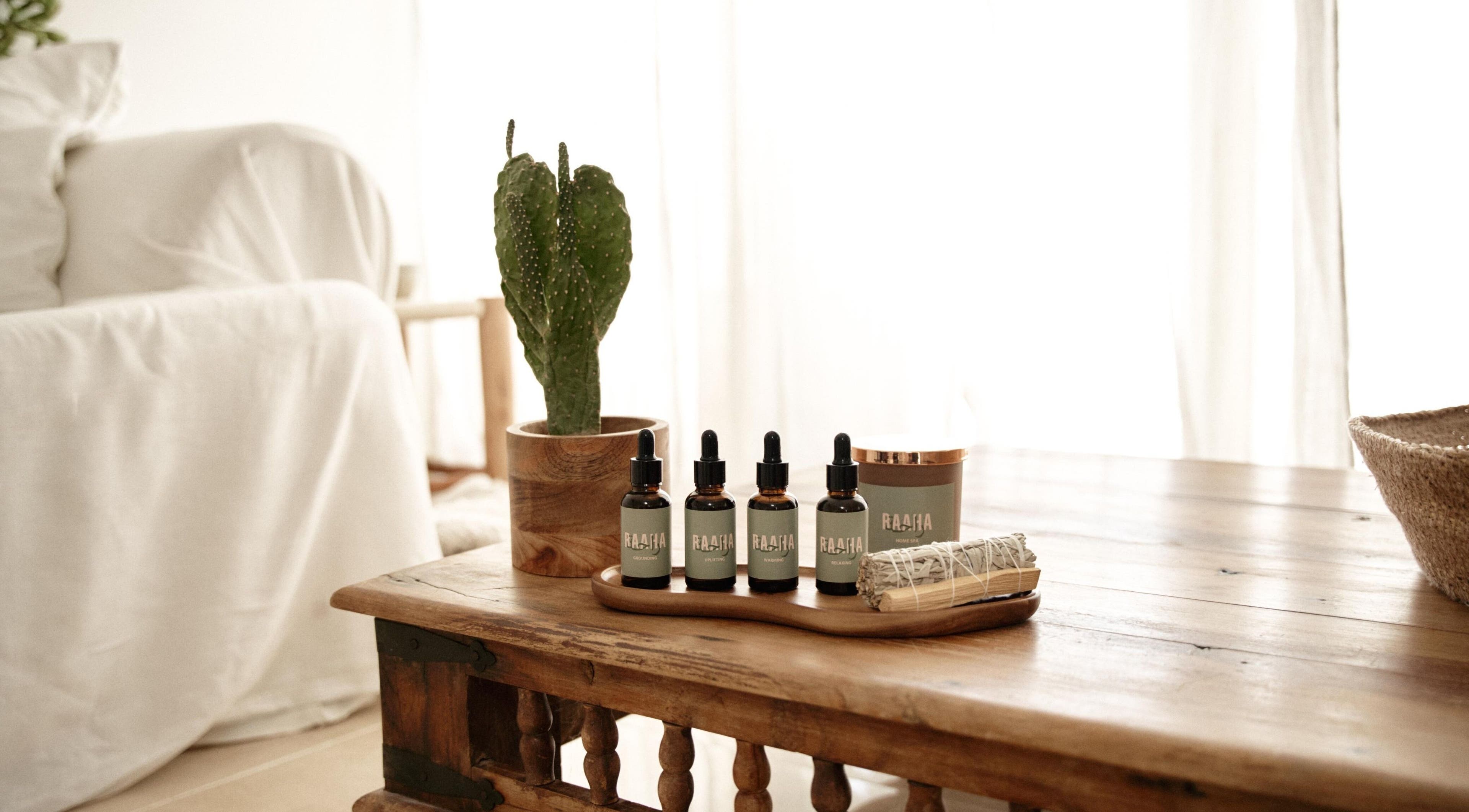 Raaha Wellness - Home Service's natural oils on a wooden table in Dubai, AE with a cozy, relaxing ambiance.