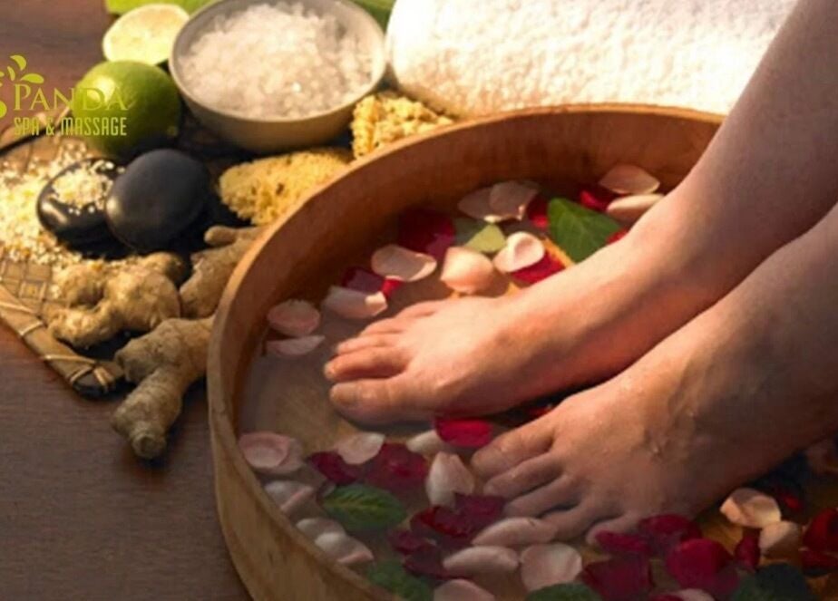 Relaxing foot soak with petals at Restore2Nature Massages, Birmingham, England, GB, promoting tranquility.