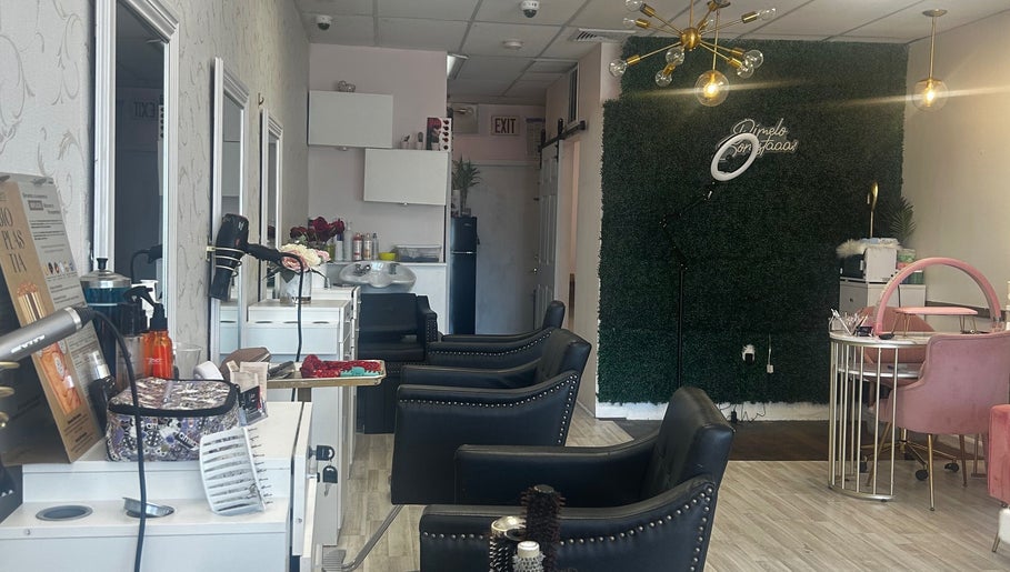 Elegant interior of Estella Dominican Hair Salon in Greenacres, Florida, US with stylish chairs and decor.