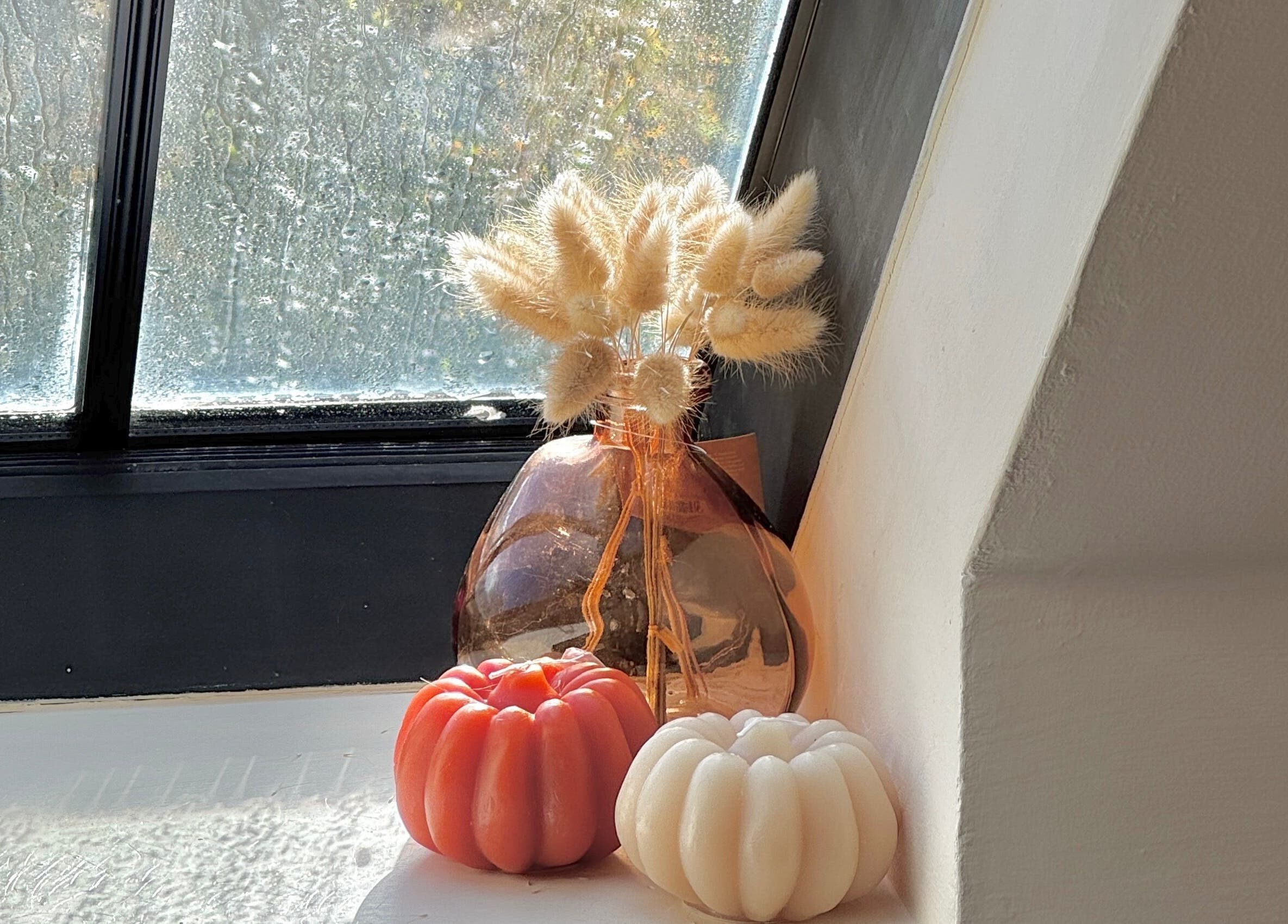 Chic window decor at Sophie's Nail Co., Melin-y-coed, Wales, GB, featuring candles and a vase.