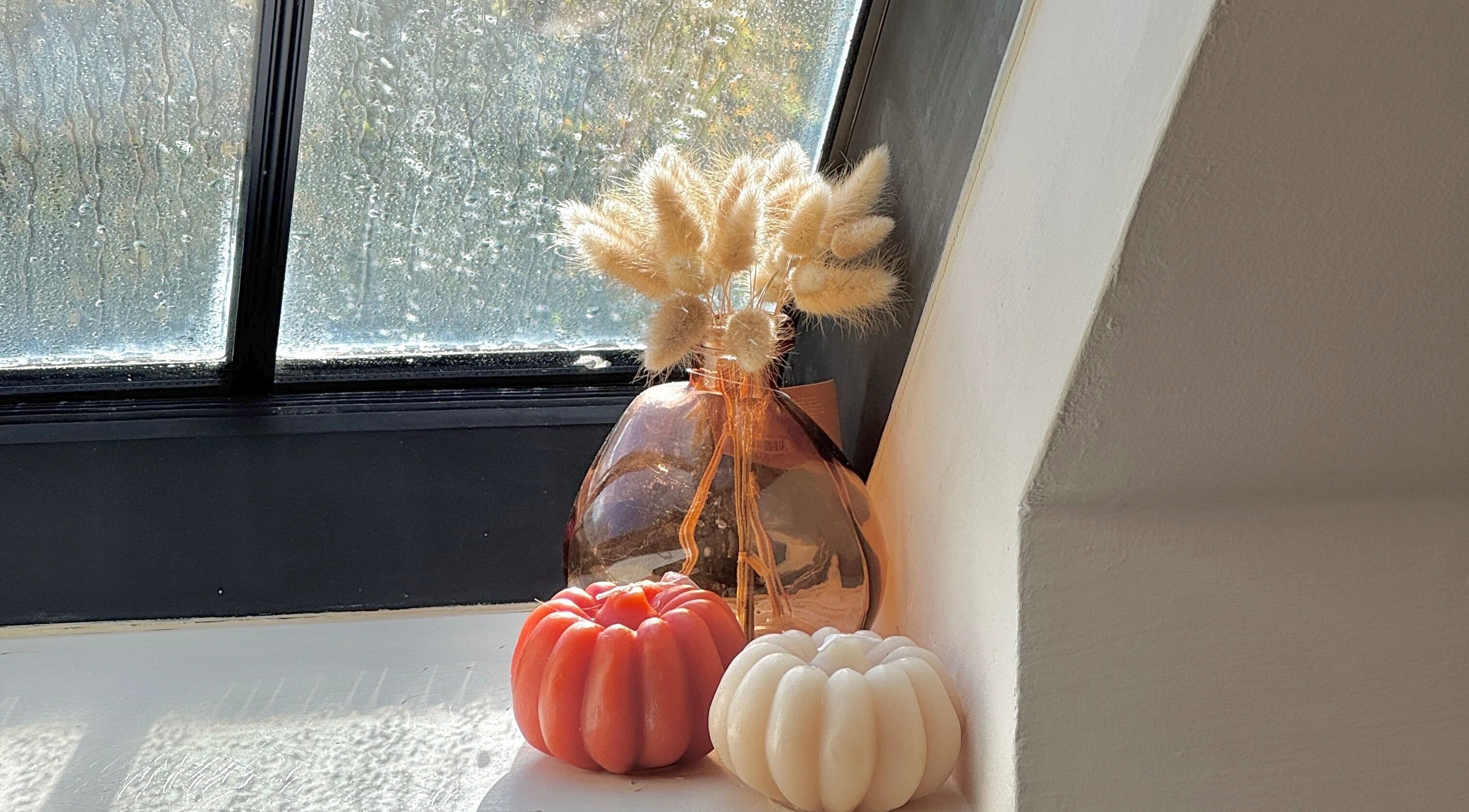 Chic window decor at Sophie's Nail Co., Melin-y-coed, Wales, GB, featuring candles and a vase.