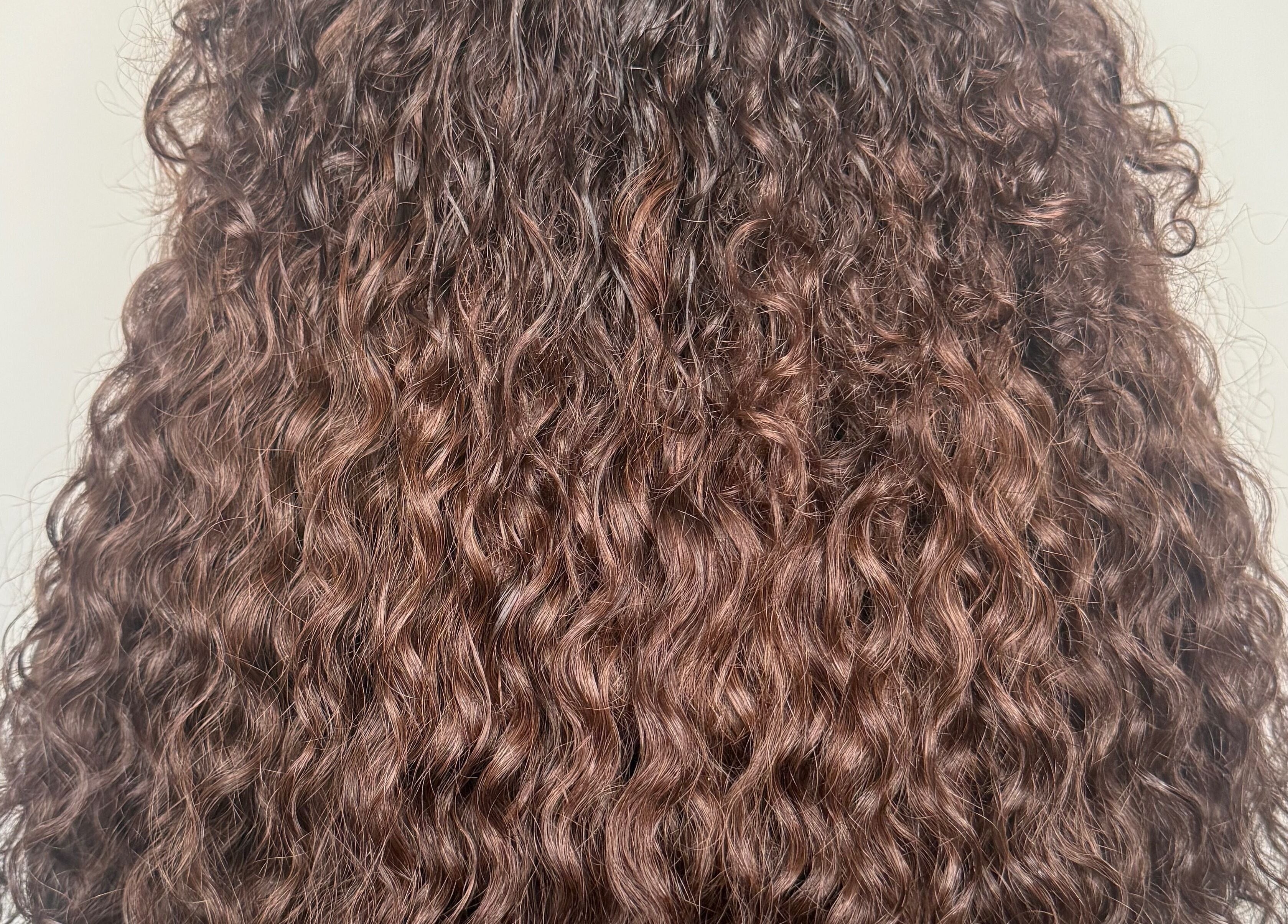 Lush curly brown hair styled at Nano extensions by Chantelle in London, Ontario, CA.