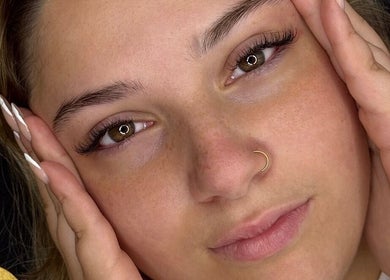 Close-up of a woman's face with radiant skin at Beauty with CS, Enfield, England, GB.