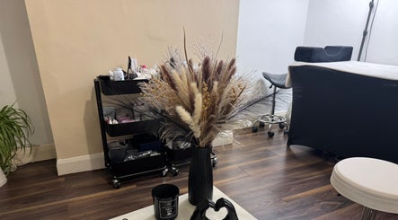 Cozy wellness corner at Beauty with CS, London, GB featuring stylish decor and floral arrangement.