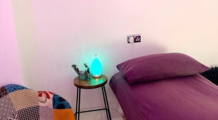 Peaceful therapy room at Reflexology and Scar Release by Nadine in Norwich, England, GB with purple bedding.