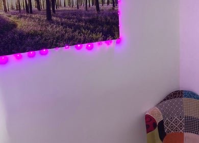 Cozy chair and purple-lit forest art at Reflexology and Scar Release by Nadine, Norwich, England, GB.