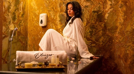 Femme détendue au spa Oleazen à Casablanca, Casablanca-settat, MA, en robe blanche sur fond de marbre.