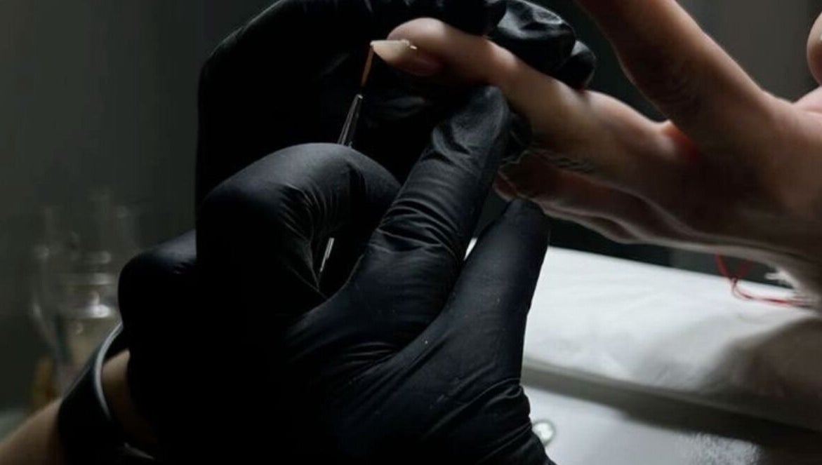 Nail technician painting nails at Elona Botsyan, Federal Way, Washington, US, enhancing beauty and wellness.