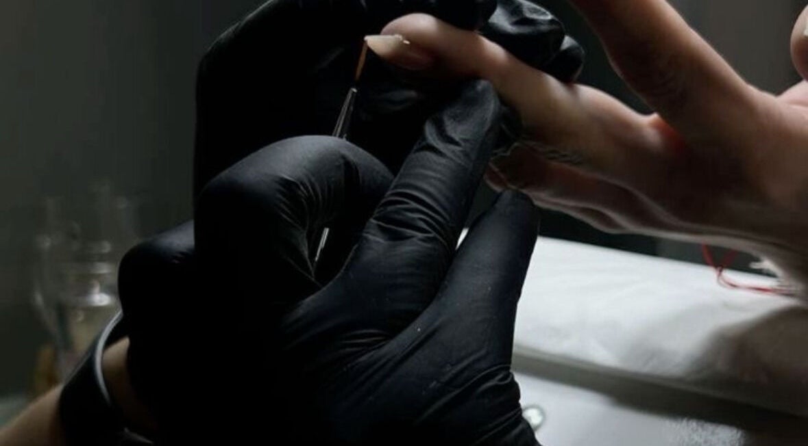 Nail technician painting nails at Elona Botsyan, Federal Way, Washington, US, enhancing beauty and wellness.