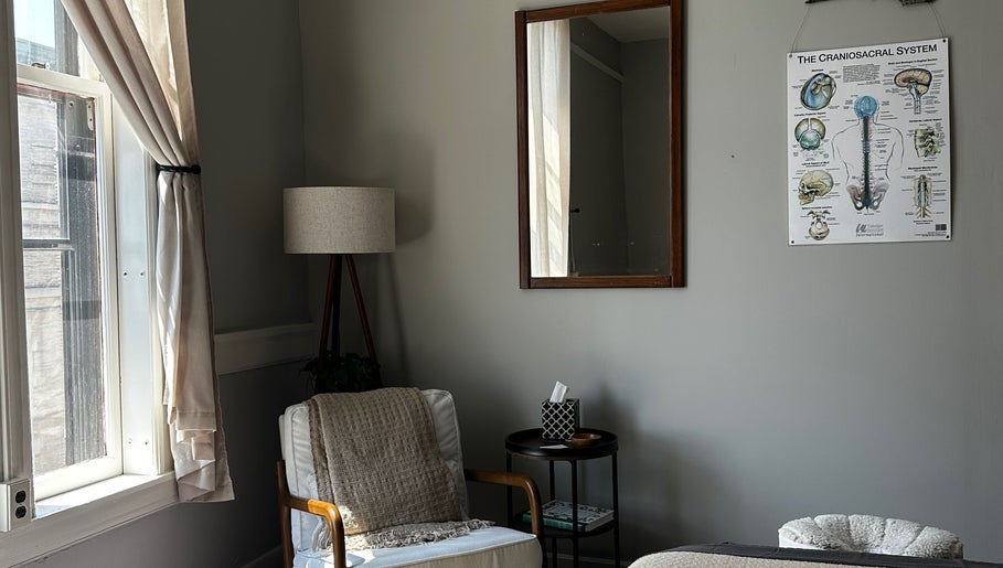 Peaceful therapy room at Nella Fusco LMT, CSP in Waterville, Maine, US with cozy chair and calming decor.