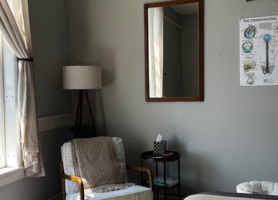 Peaceful therapy room at Nella Fusco LMT, CSP in Waterville, Maine, US with cozy chair and calming decor.