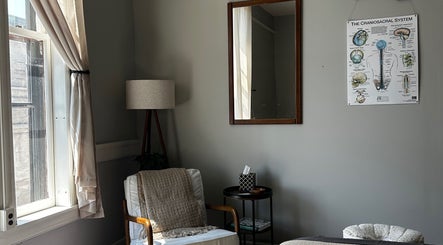 Peaceful therapy room at Nella Fusco LMT, CSP in Waterville, Maine, US with cozy chair and calming decor.