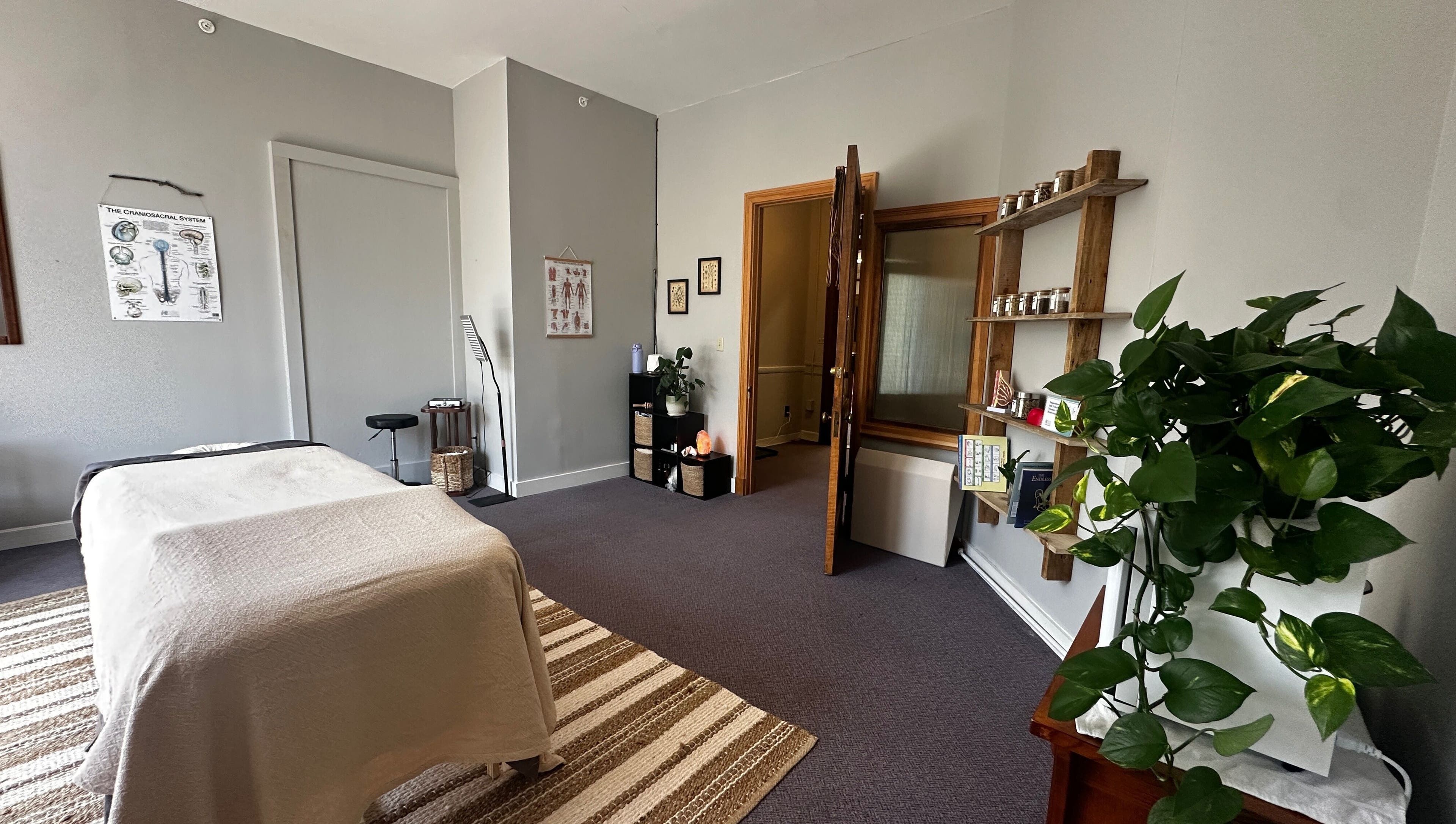 Tranquil massage room at Nella Fusco LMT, CSP in Waterville, Maine, US with table and relaxing decor.
