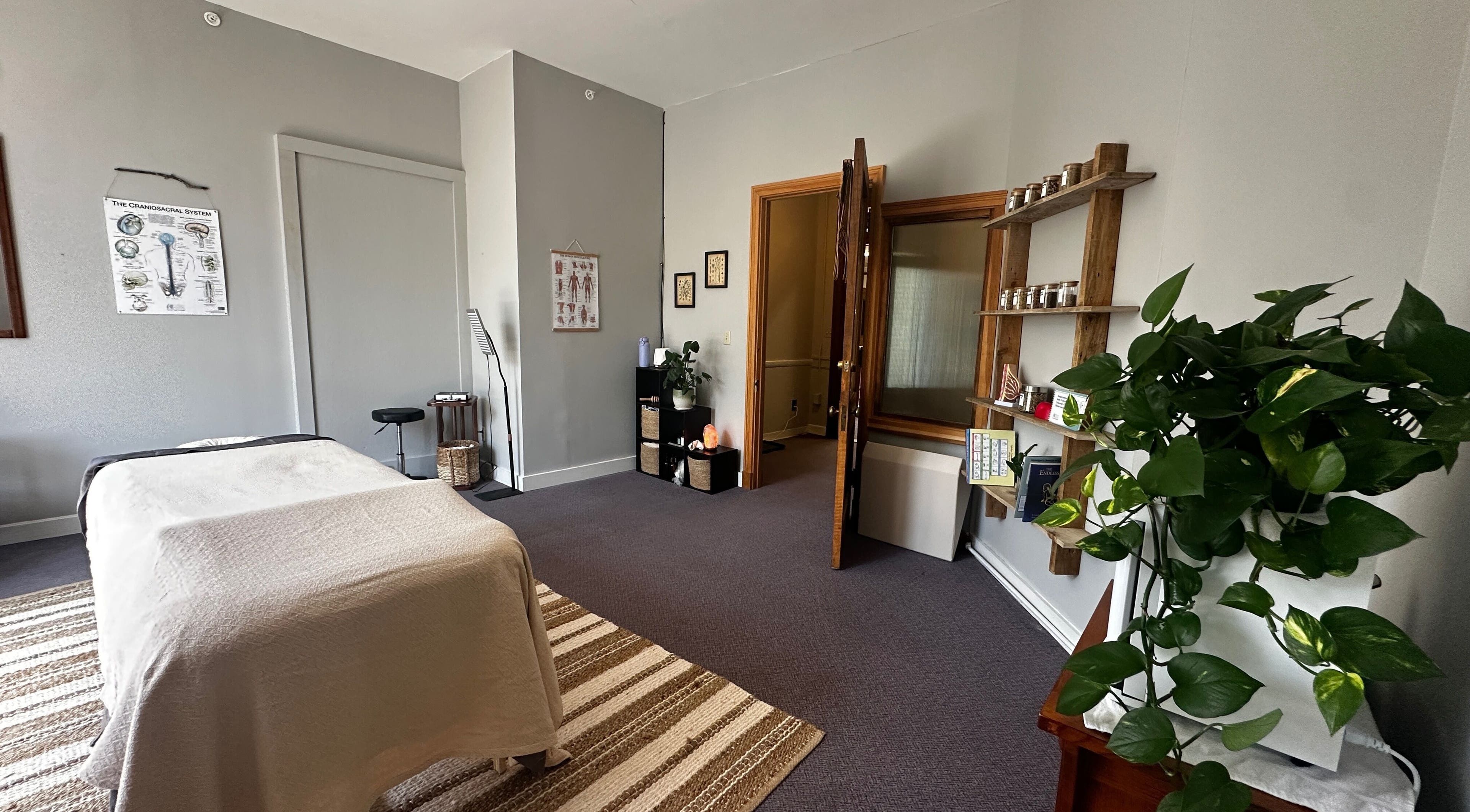 Tranquil massage room at Nella Fusco LMT, CSP in Waterville, Maine, US with table and relaxing decor.
