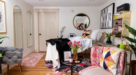 Elegant treatment room at Physiques Boutique in Seattle, Washington, US, featuring modern decor and vibrant accents.