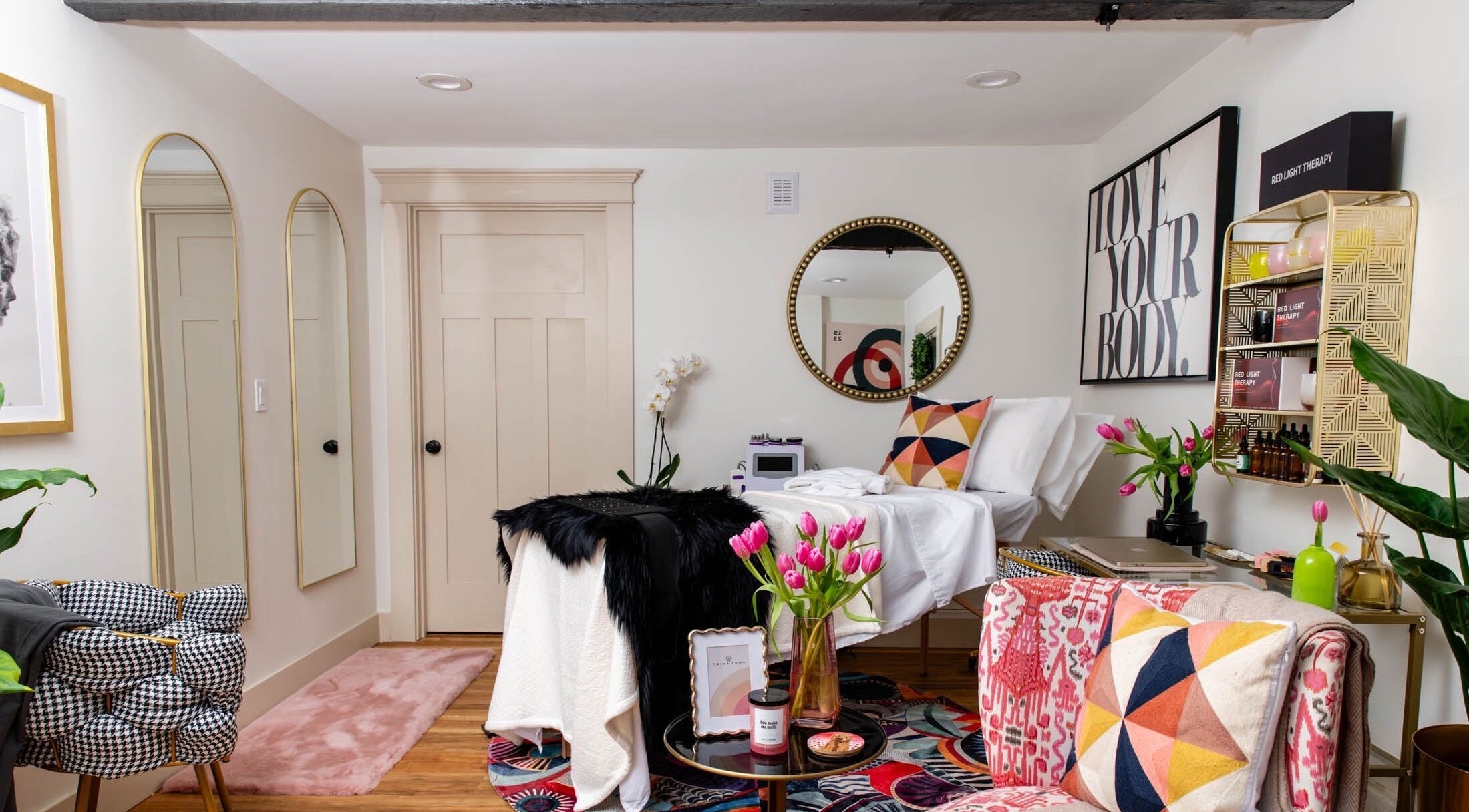 Luxurious treatment room at Physiques Boutique in Seattle, Washington, US, featuring elegant decor and plush seating.