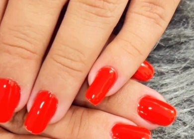 Unhas pintadas de vermelho brilhante na Lenita Manicure, São Paulo, São Paulo, BR.