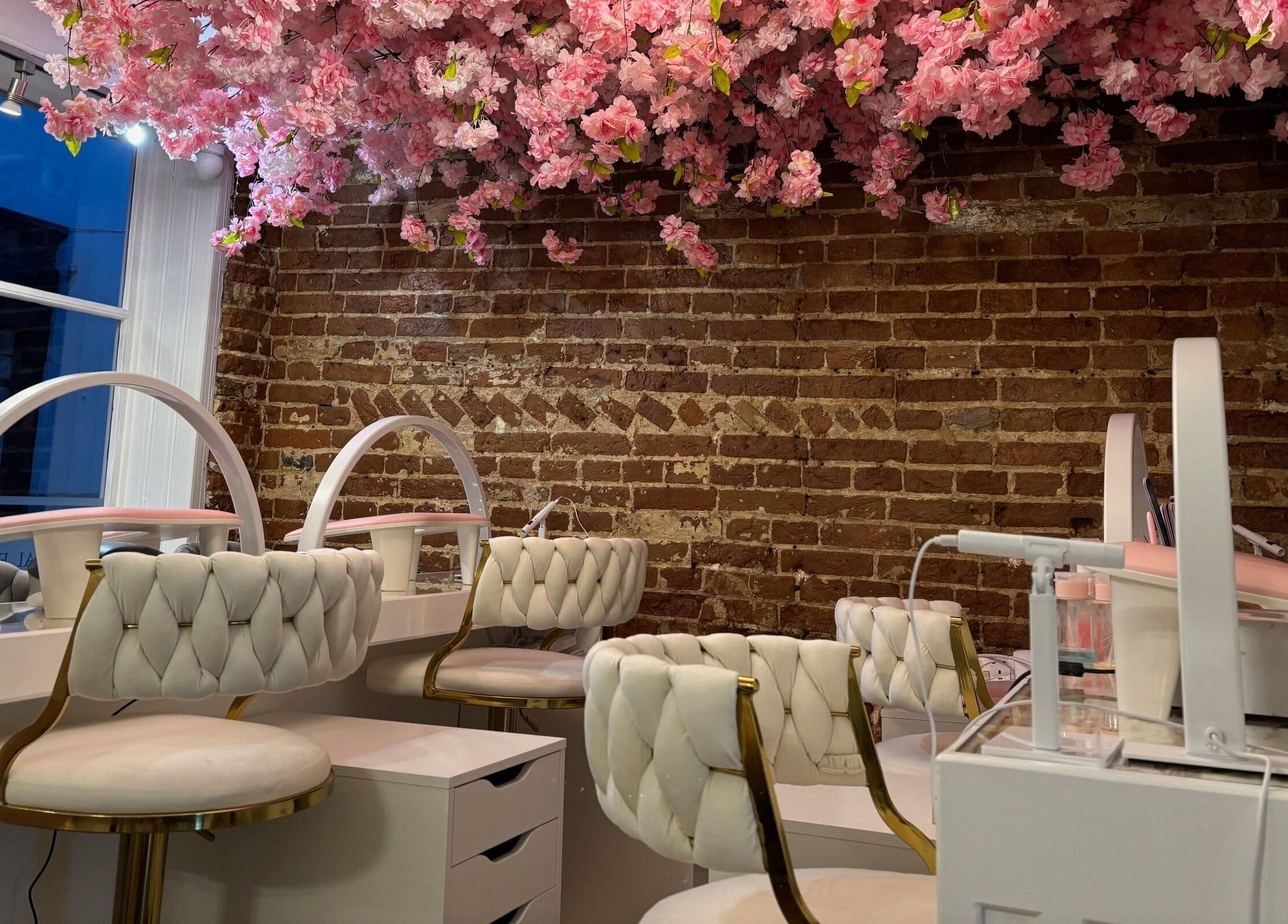 Elegant beauty station at The Blossom Clinic, Beccles, England, GB, with floral ceiling and plush chairs.