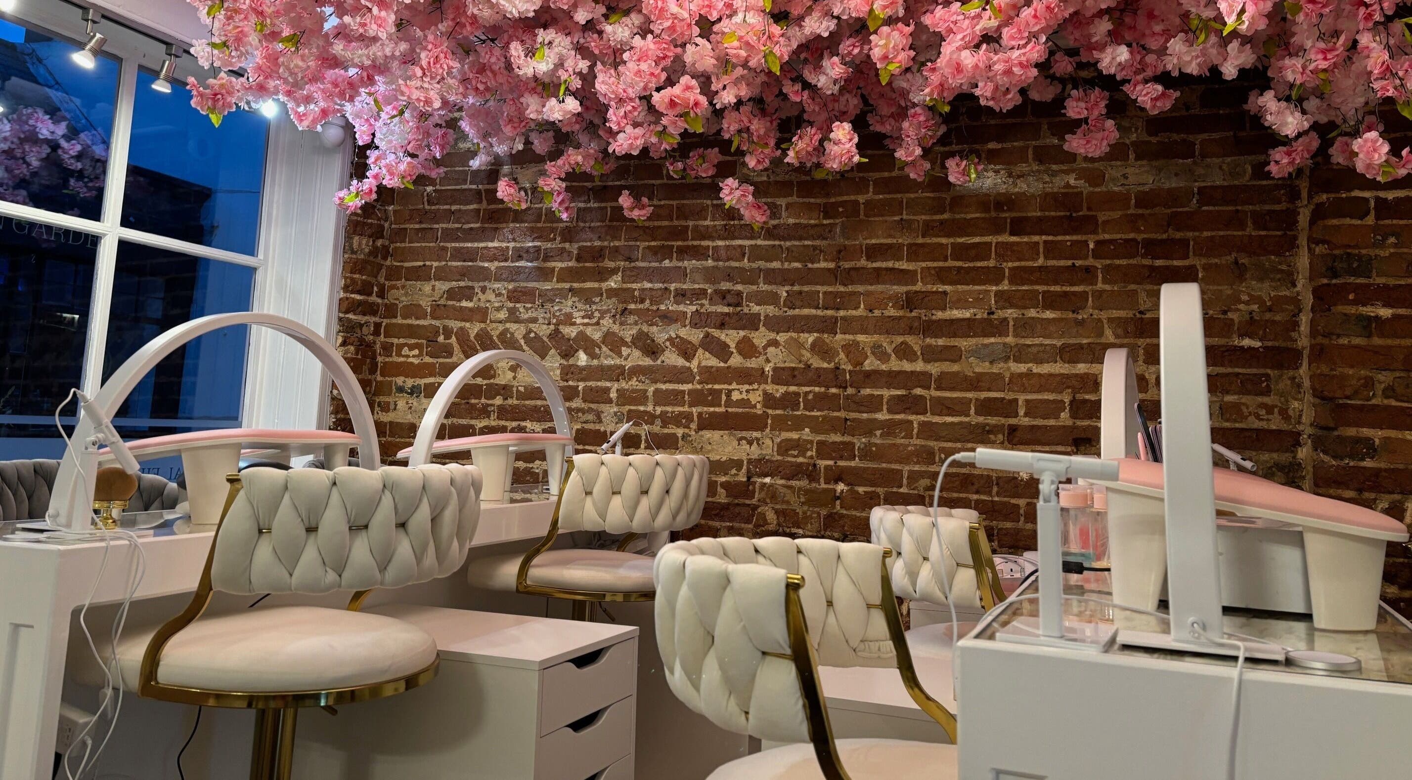 Elegant beauty station at The Blossom Clinic, Beccles, England, GB, with floral ceiling and plush chairs.