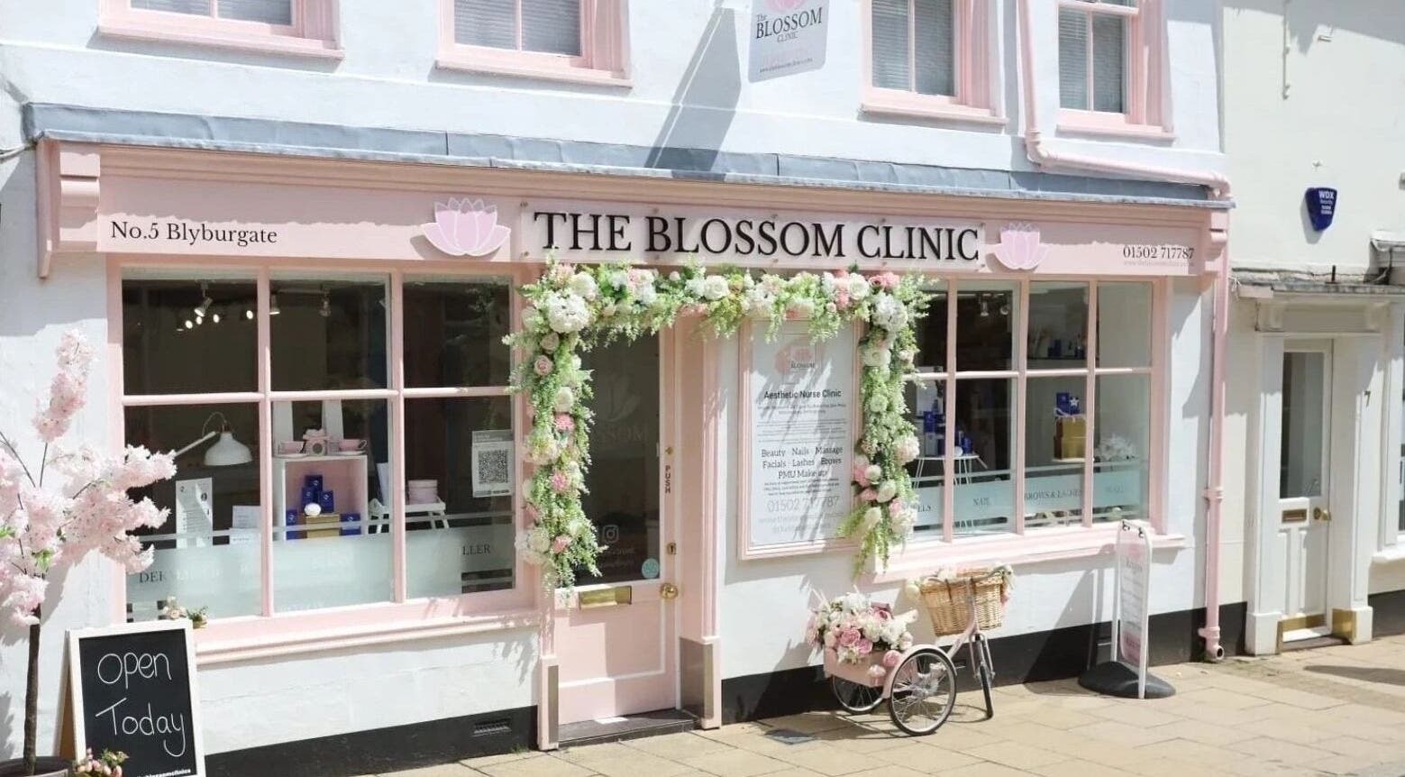 Charming facade of The Blossom Clinic in Beccles, England, GB adorned with floral decorations.
