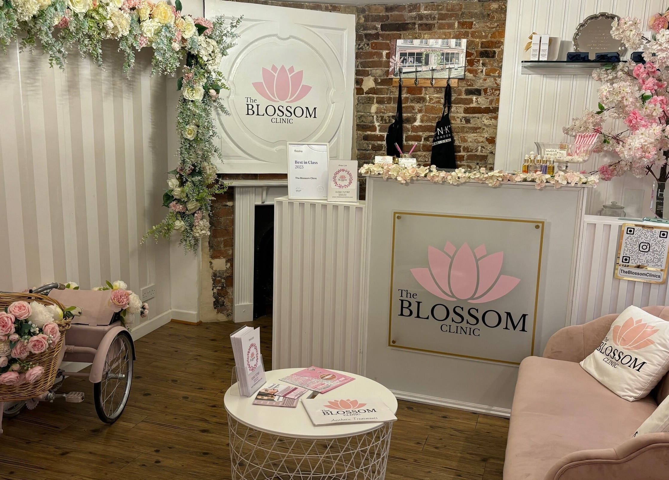 Reception area of The Blossom Clinic in Beccles, England, GB, featuring floral decor and comfortable seating.