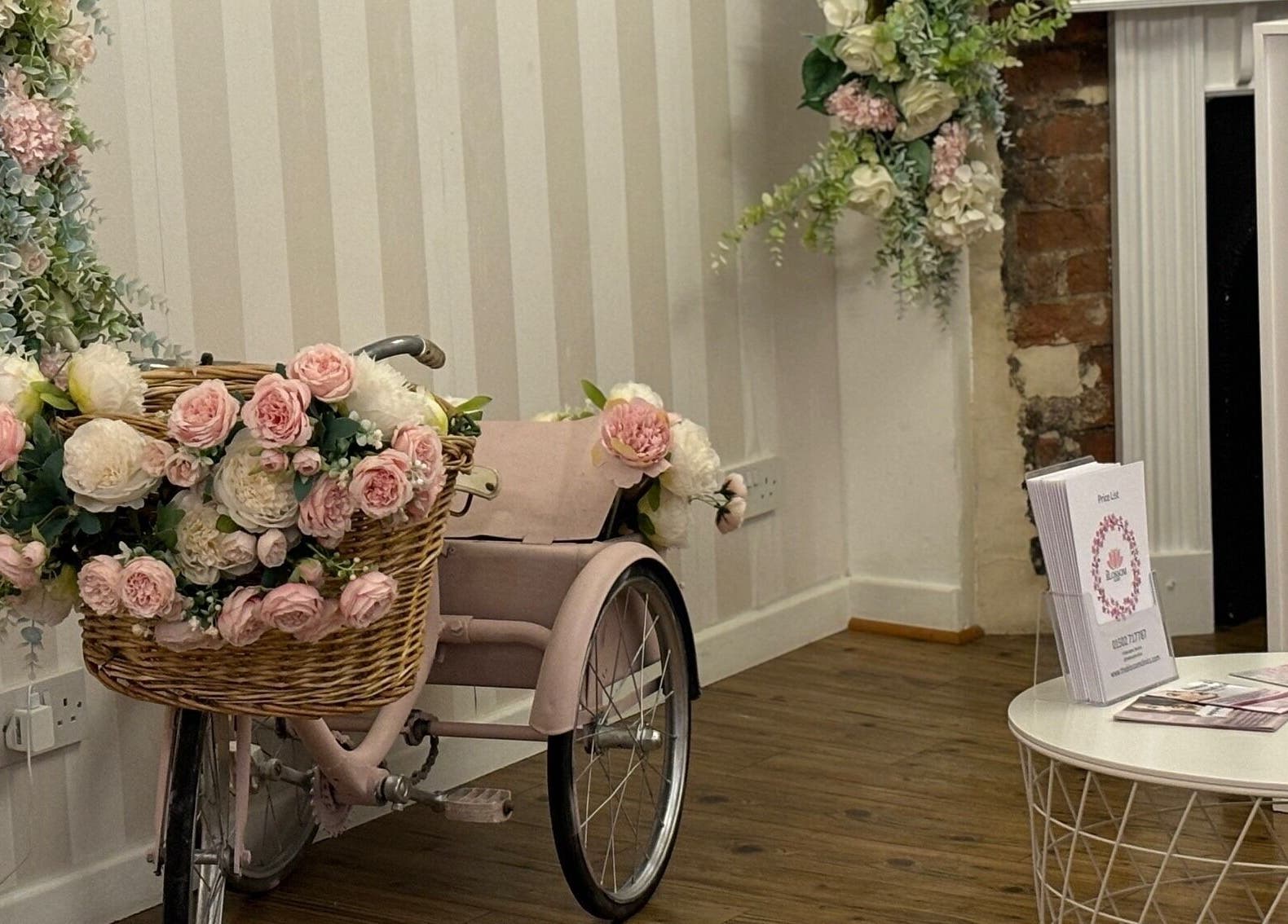 Charming floral tricycle decor at The Blossom Clinic in Beccles, England, GB. Stylish interior design.