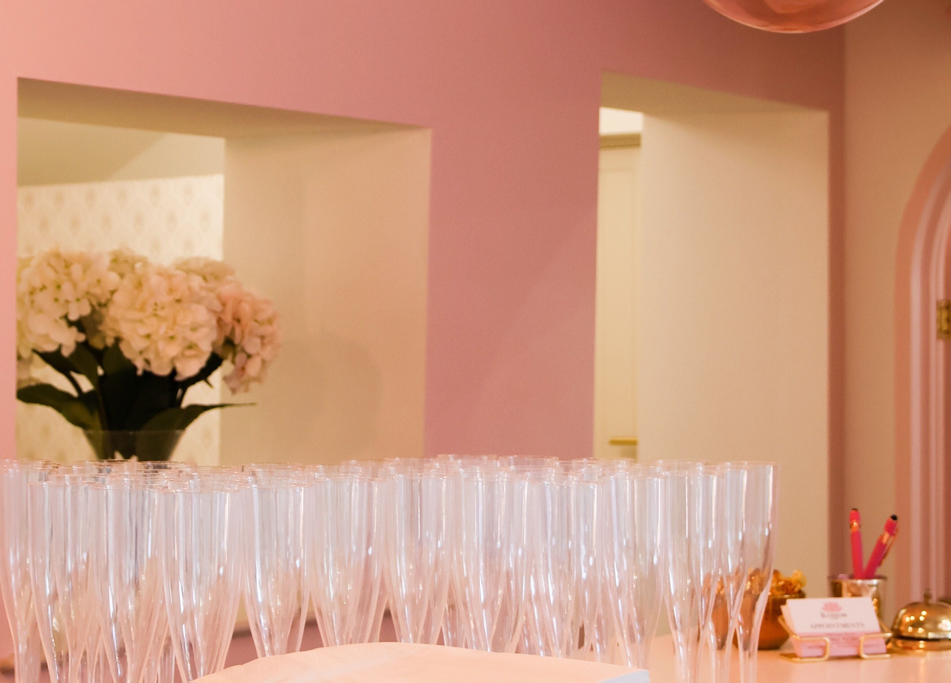 Reception area at The Blossom Clinic, Beccles, England, GB with pink decor and elegant glassware.