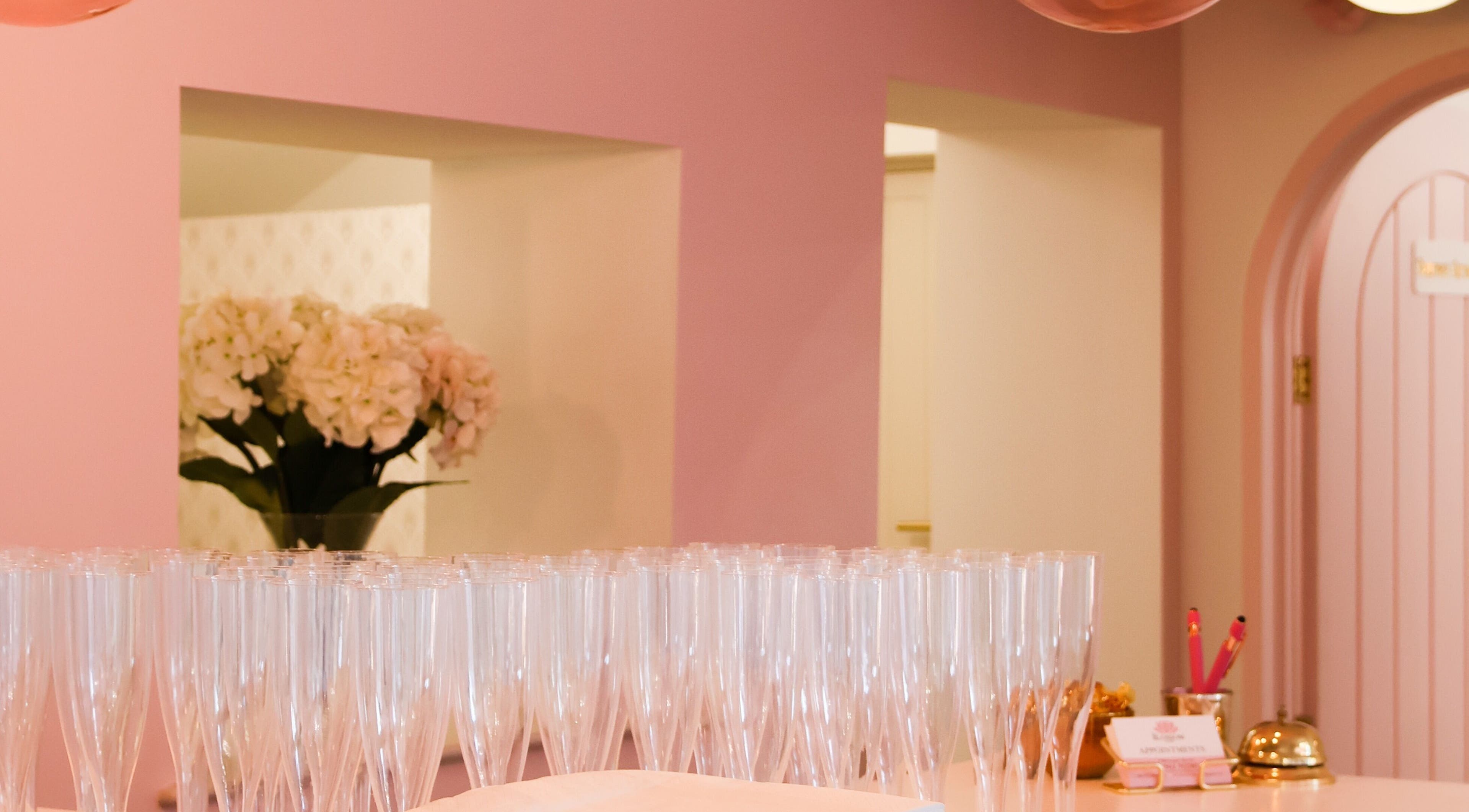 Reception area at The Blossom Clinic, Beccles, England, GB with pink decor and elegant glassware.