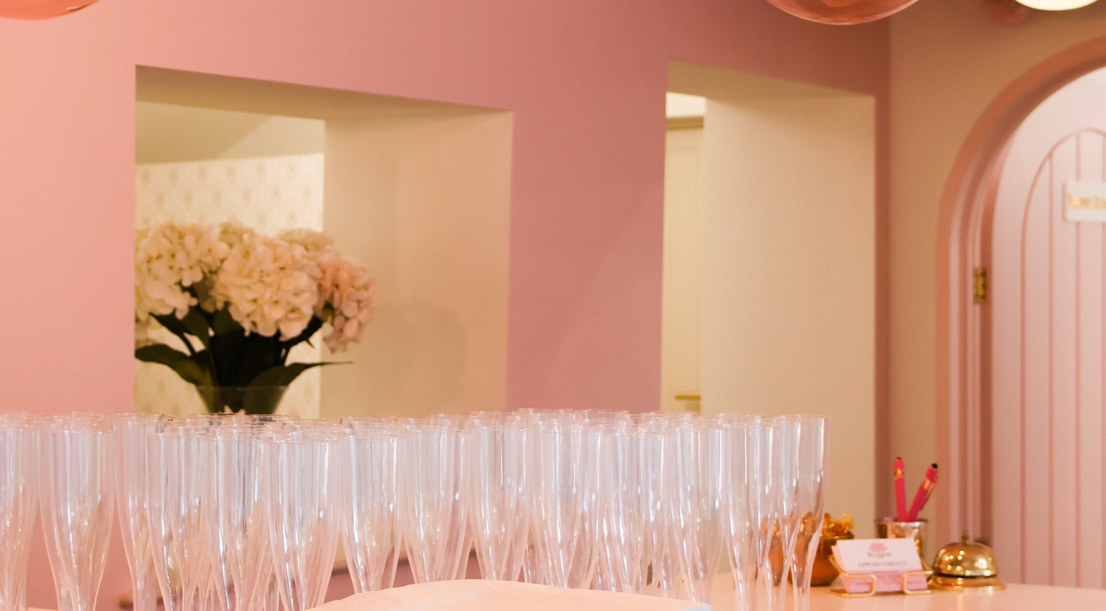 Reception area at The Blossom Clinic, Beccles, England, GB with pink decor and elegant glassware.