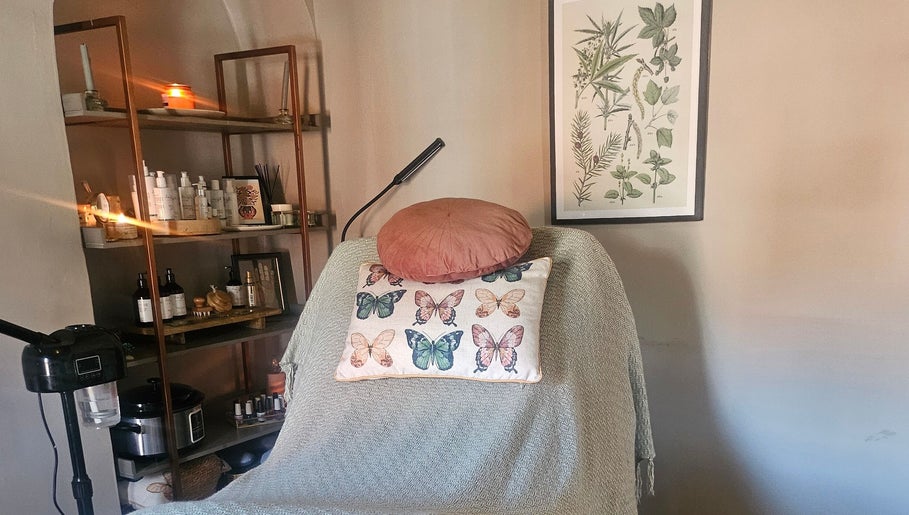 Cozy treatment room at Healing Hands with Alli in Grantham, England, GB. Decor includes butterflies and plants.