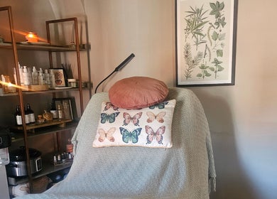 Cozy treatment room at Healing Hands with Alli in Grantham, England, GB. Decor includes butterflies and plants.