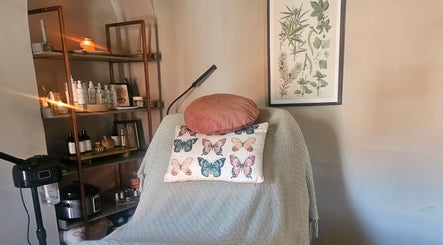 Cozy treatment room at Healing Hands with Alli in Grantham, England, GB. Decor includes butterflies and plants.