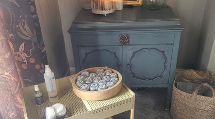 Cozy wellness corner at Healing Hands with Alli, Grantham, England, featuring skincare products and rustic decor.