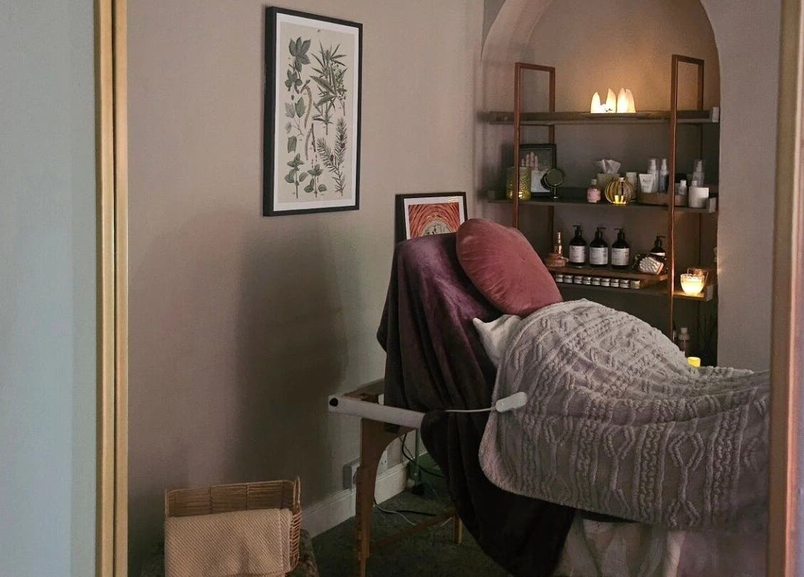 Cozy treatment room at Healing Hands with Alli, Grantham, England, GB, featuring a massage table and calming decor.