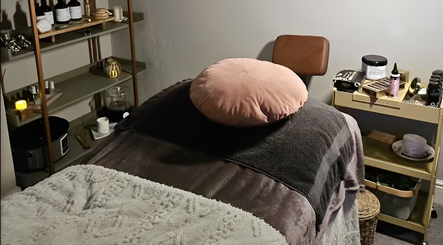 Cozy massage room at Healing Hands with Alli in Grantham, England, GB with soft linens and ambient shelves.