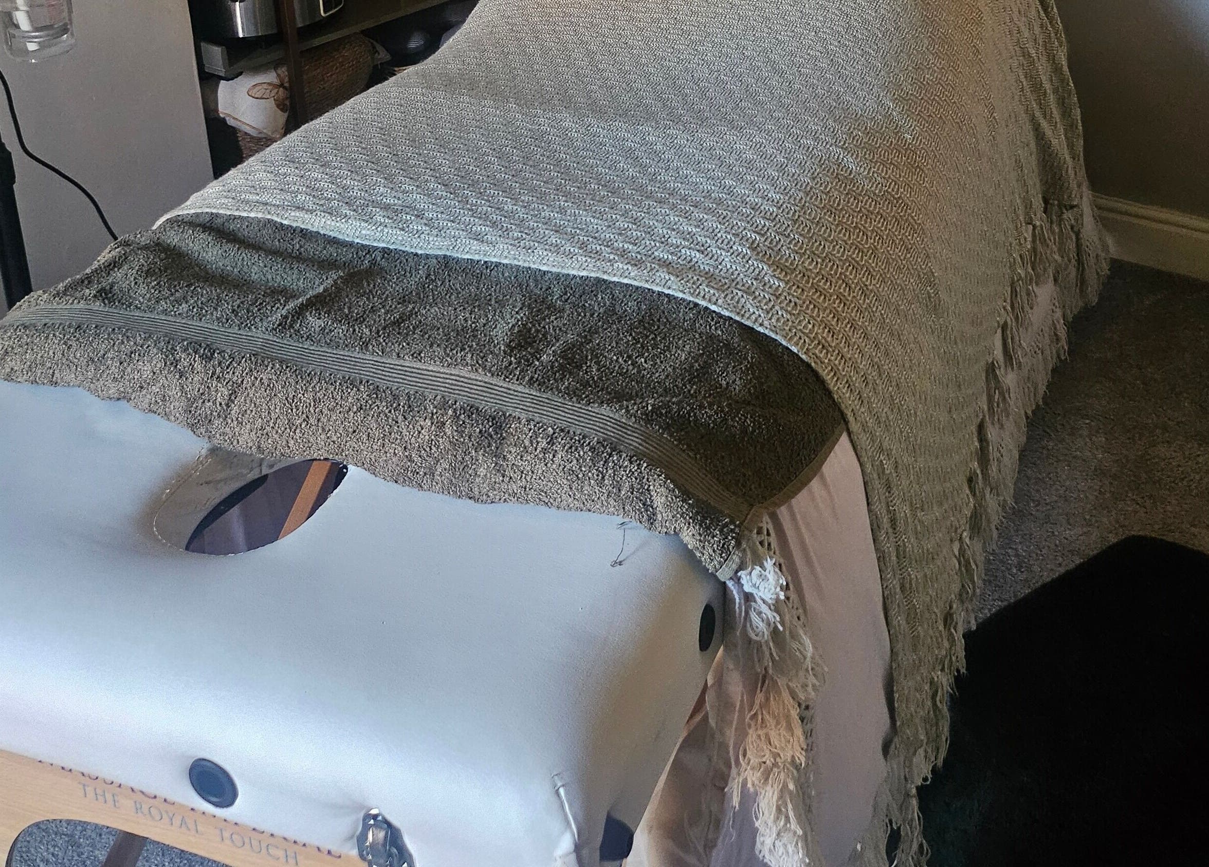 Cozy massage table at Healing Hands with Alli, Grantham, England, GB, featuring soft blankets and soothing atmosphere.