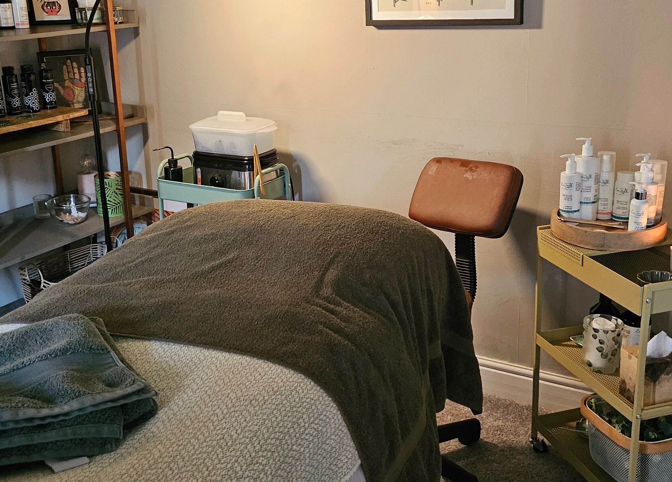 Tranquil treatment room at Healing Hands with Alli, Grantham, England, GB, featuring massage table and wellness products.