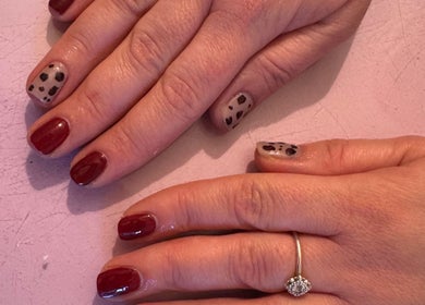 Elegant nail art with classic red and leopard print at Dazzling Beauty, King's Lynn, England, GB.