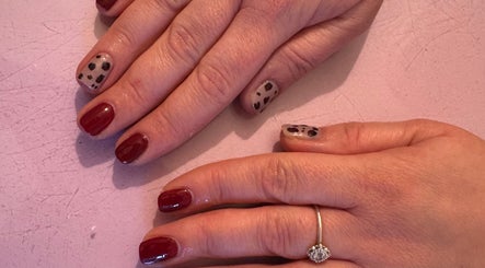 Elegant nail art with classic red and leopard print at Dazzling Beauty, King's Lynn, England, GB.