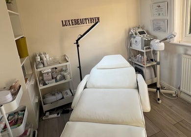 Relaxing treatment room at Luxebeautybyem in Manchester, England, GB, featuring modern spa equipment.
