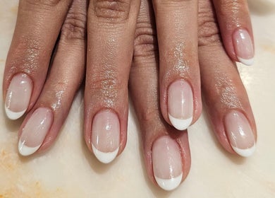 Perfectly manicured French tips at Xhensila Beauty Studio, Luton, England, GB. Nails polished to perfection.