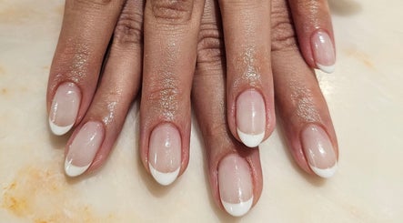 Perfectly manicured French tips at Xhensila Beauty Studio, Luton, England, GB. Nails polished to perfection.