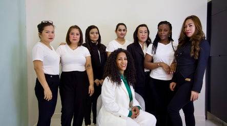 Cynthilante Beauty Salon team posing in Dubai, Dubai, AE, showcasing diverse staff in professional attire.